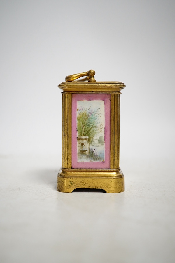 A miniature brass and enamel figurative panelled carriage timepiece, 7cm high. Condition - both gilt and enamel panels marked